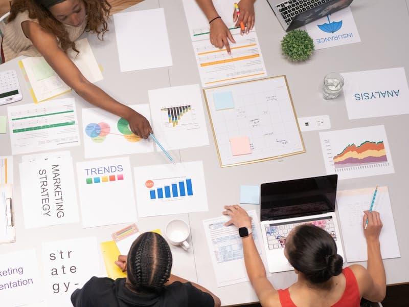 Overhead view of brand strategy documents with artistic visuals for business planning
